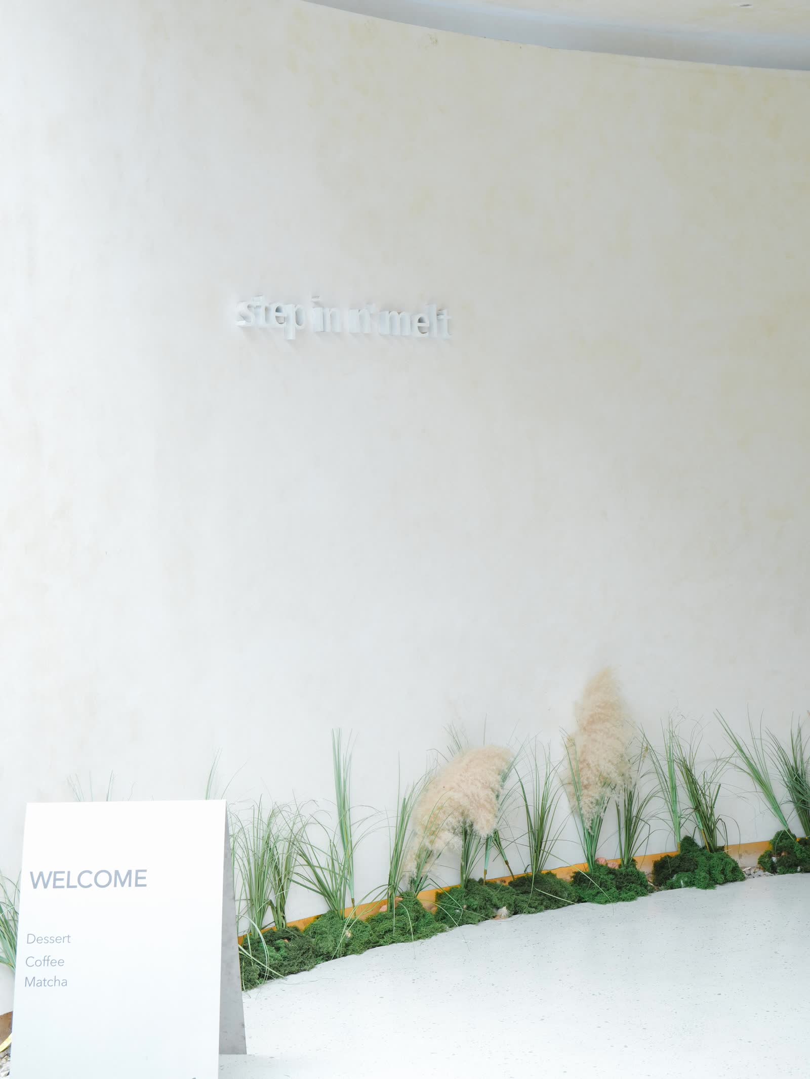 Step in at Melt Me — entrance with pampas grass and welcome board