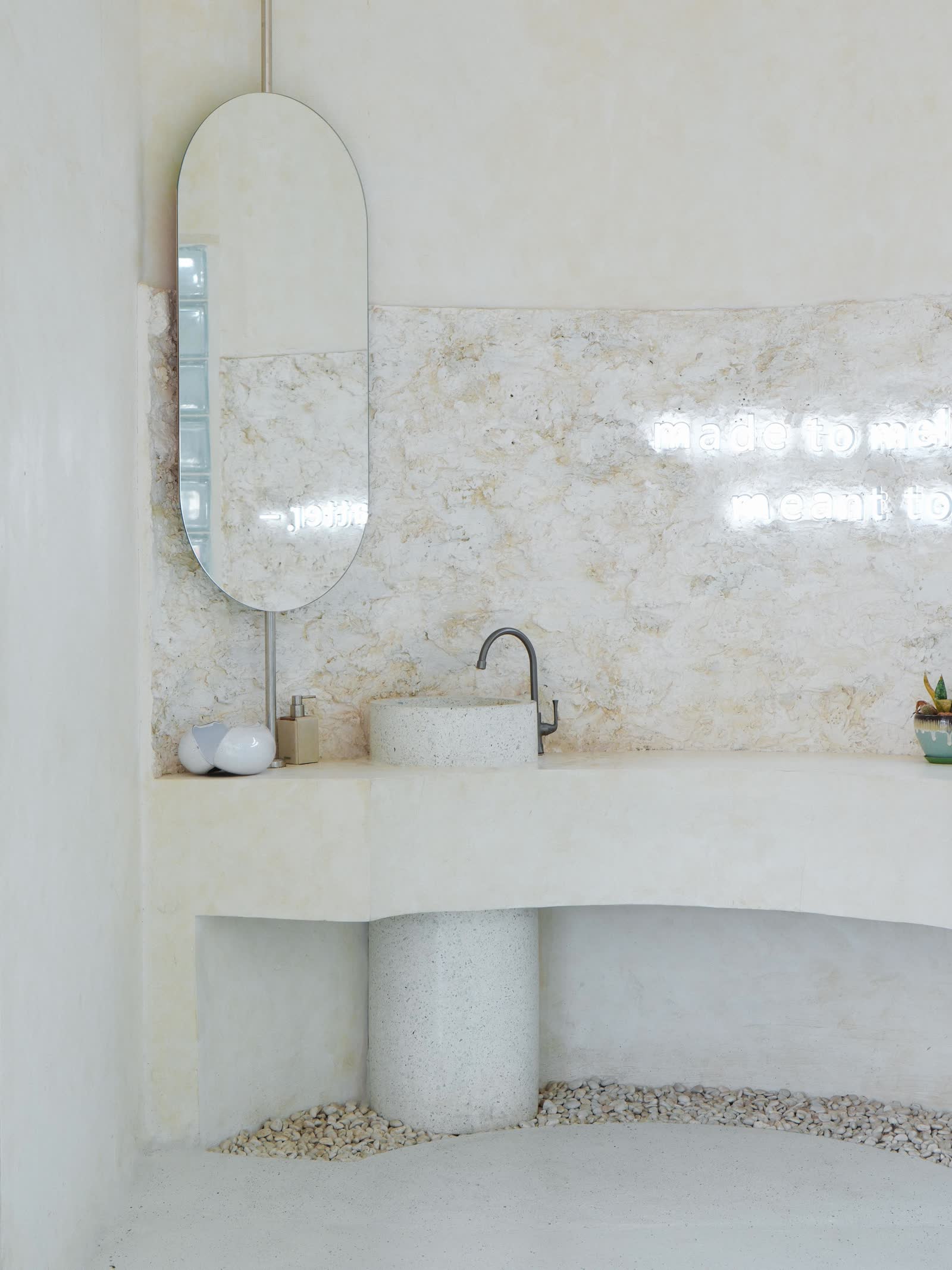 Melt Me powder room with marble wall and neon tagline